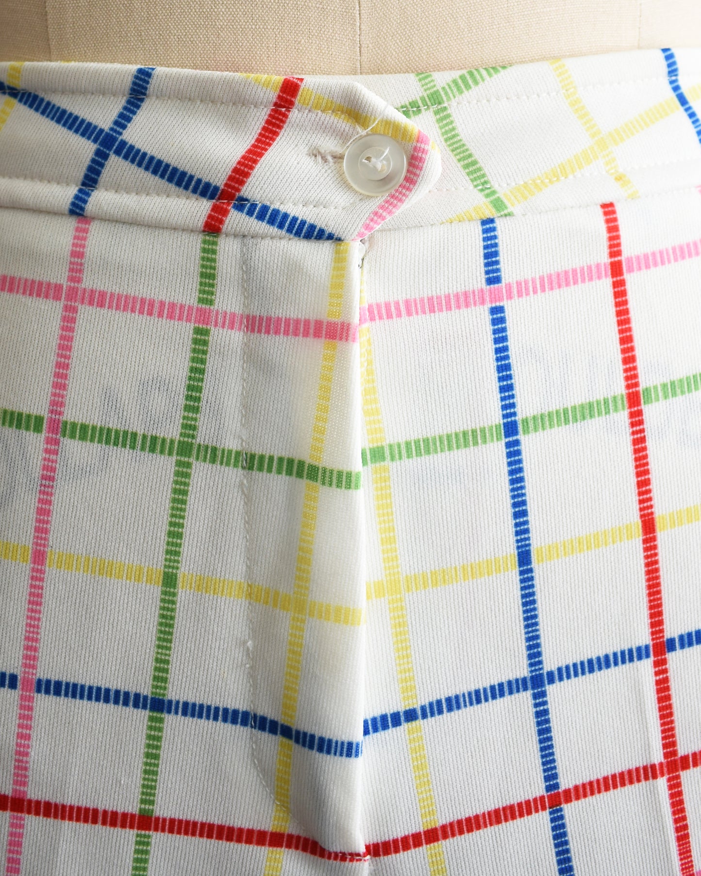 close up of the button and rainbow stripes on the shorts