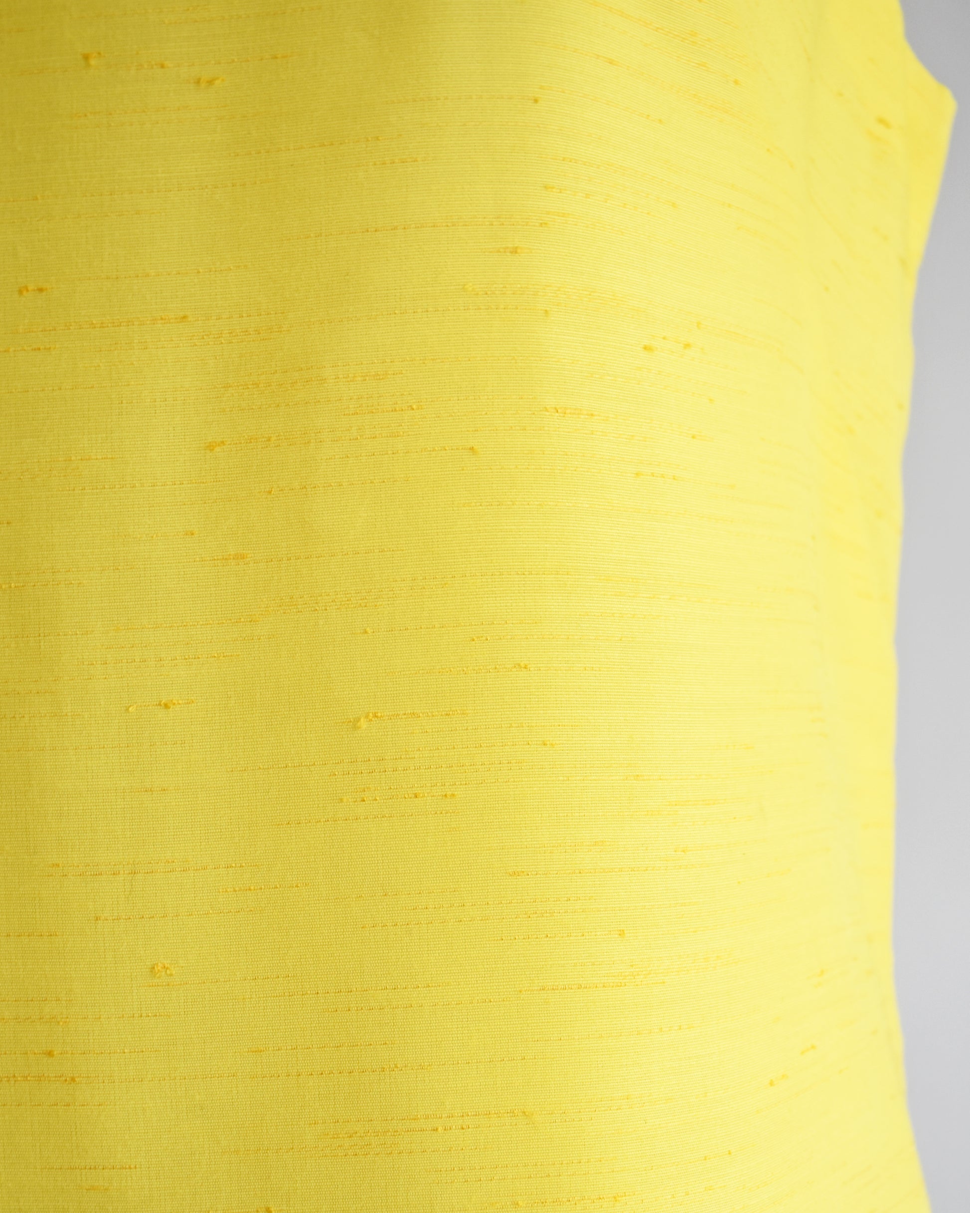 close up of the yellow fabric that has horizontal slubs