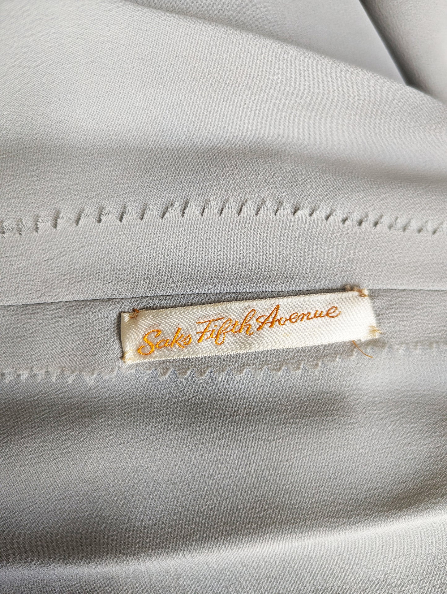 close up of the tag which says Saks Fifth Avenue