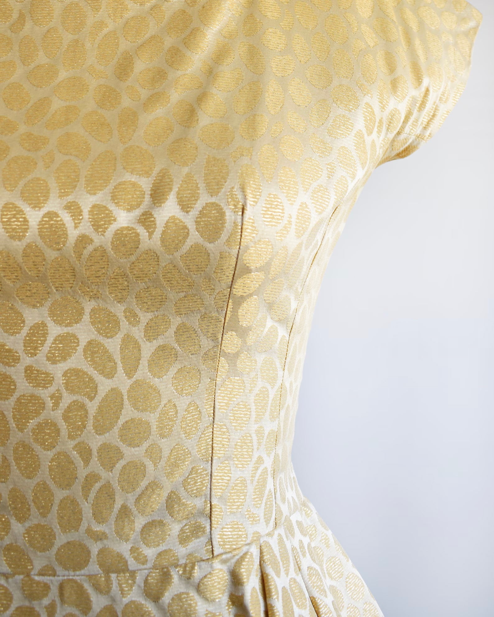 Close up of the metallic gold fabric and polka dot-esque print