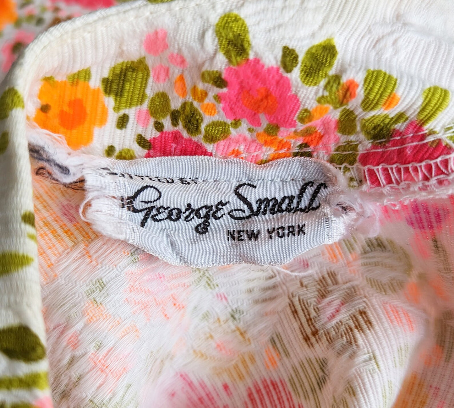 Close up of the tag that says Styled by George Small New York