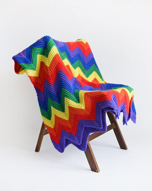 A vintage rainbow chevron striped blanket on a chair