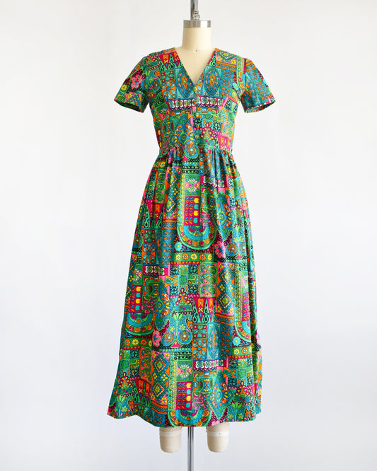 front view of a vintage 60s multicolored and multi-print floral maxi dress on a dress form
