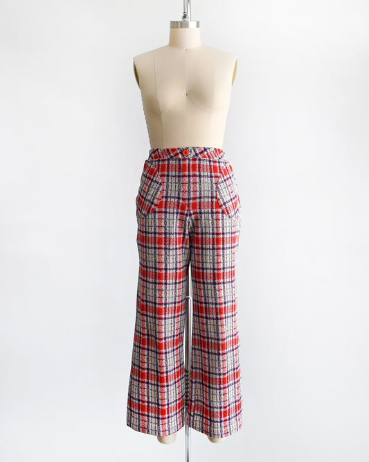A vintage pair of 70s red white and blue plaid wide leg pants on a dress form.