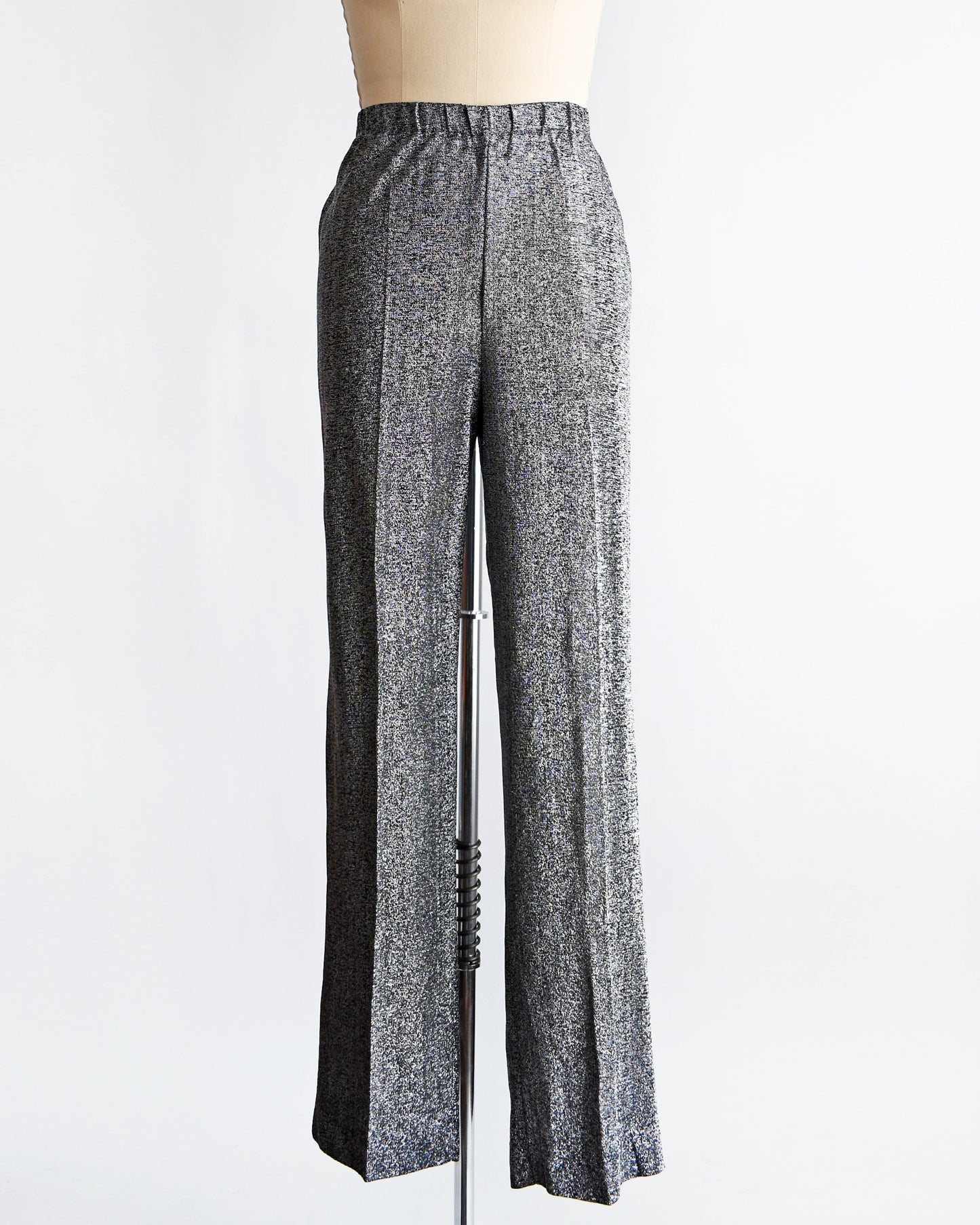 A vintage pair of 70s silver and black metallic pants on a dress form.