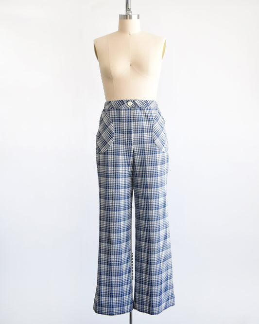 A vintage pair of 70s blue and white plaid wide leg pants on a dress form.