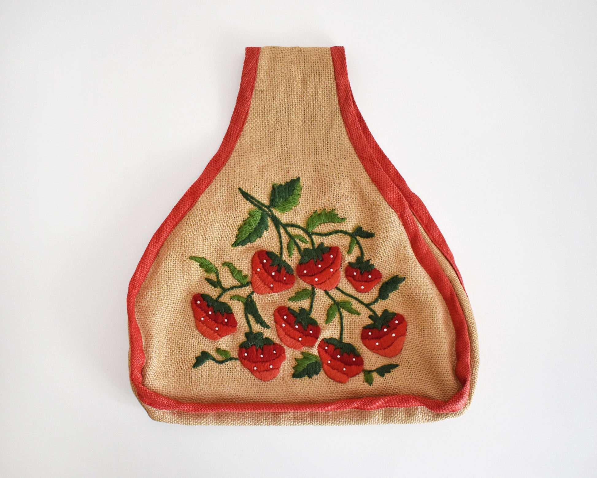 A vintage 60s burlap purse that has  embroidered strawberries on the front, with green leaves and small white pearl beaded seeds and red trim.